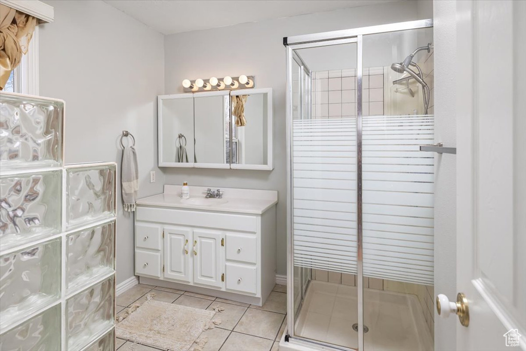 Bathroom with vanity, walk in shower, and tile flooring