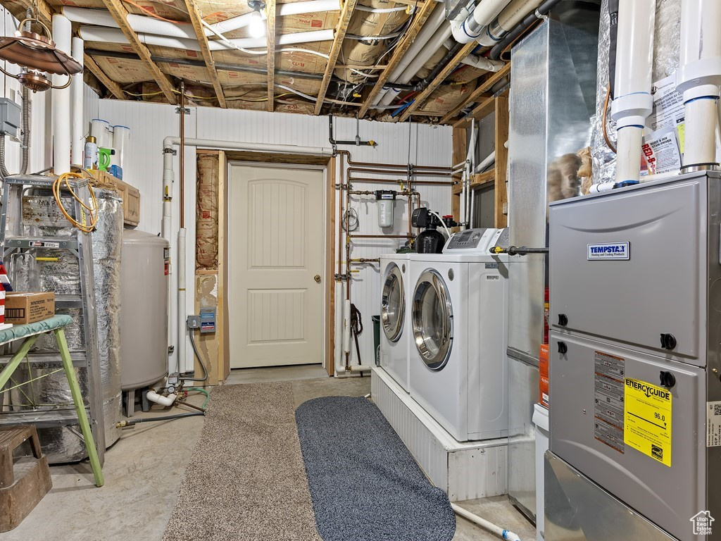 Laundry area featuring washer and dryer and gas water heater