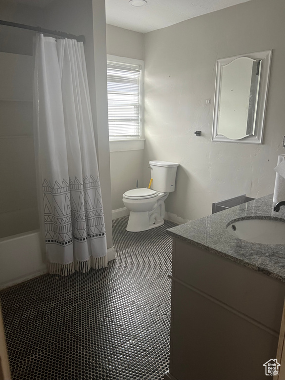 Full bathroom featuring vanity, toilet, and shower / bath combo with shower curtain