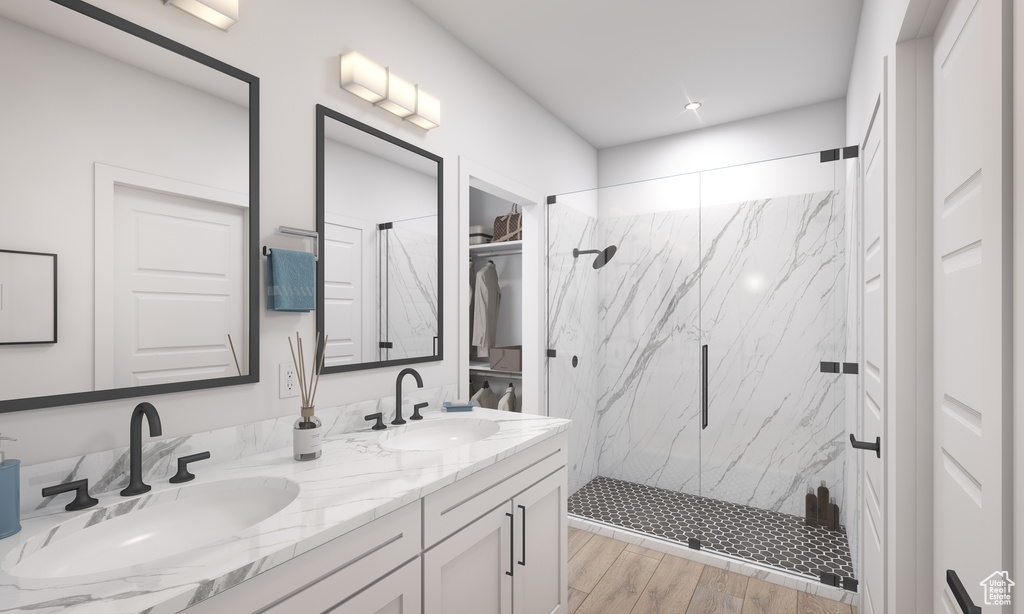 Bathroom with tiled shower, hardwood / wood-style flooring, and dual bowl vanity
