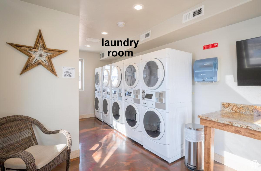 Laundry room with stacked washer / drying machine and washer and clothes dryer