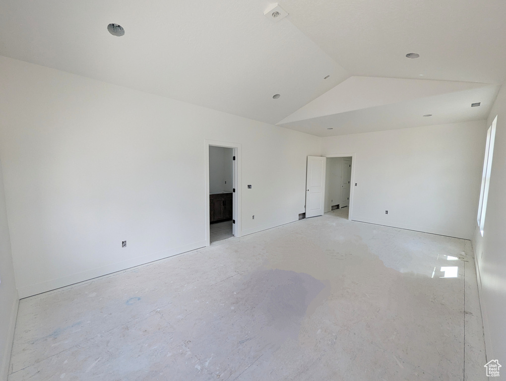 Empty room with lofted ceiling