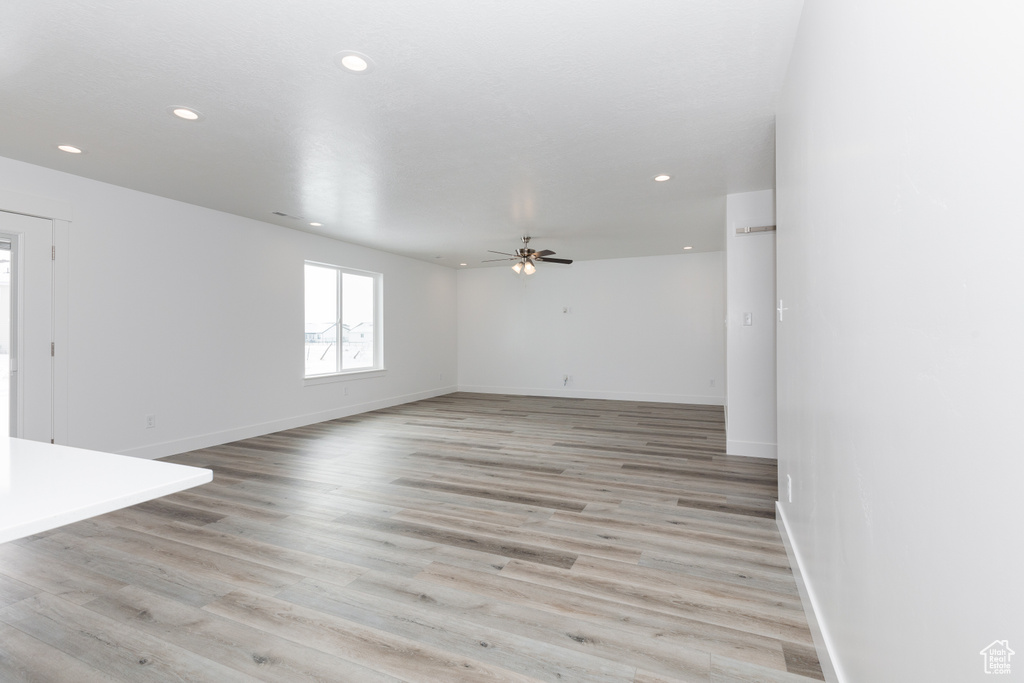 Unfurnished room with light hardwood / wood-style floors and ceiling fan