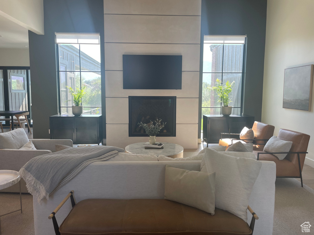 Carpeted living room with plenty of natural light and a fireplace