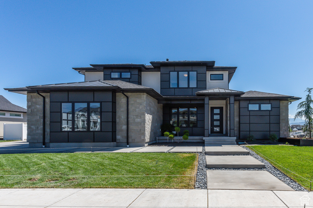 Prairie-style house with a front yard and french doors