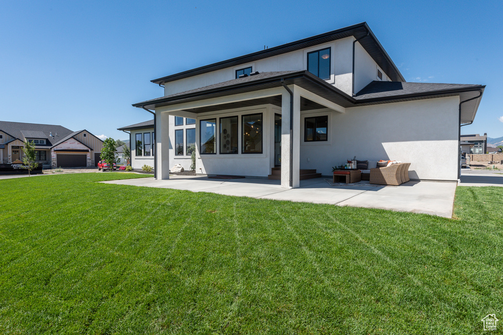 Rear view of property with a yard and an outdoor living space