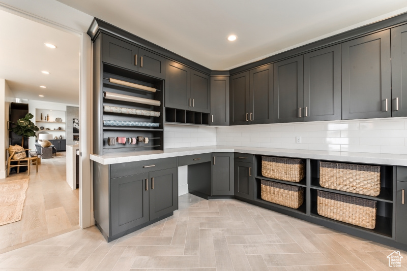 Kitchen featuring tasteful backsplash and light hardwood / wood-style flooring