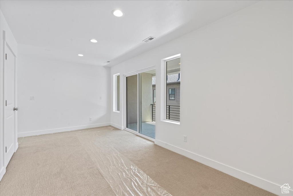 Empty room featuring light carpet