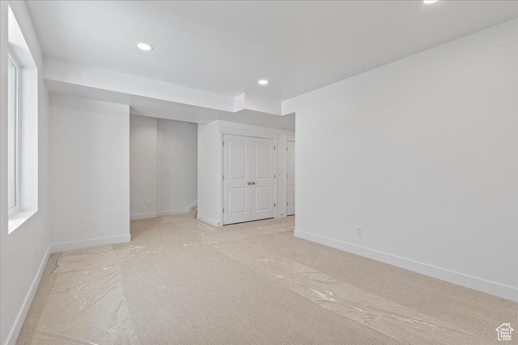 Unfurnished bedroom with light carpet