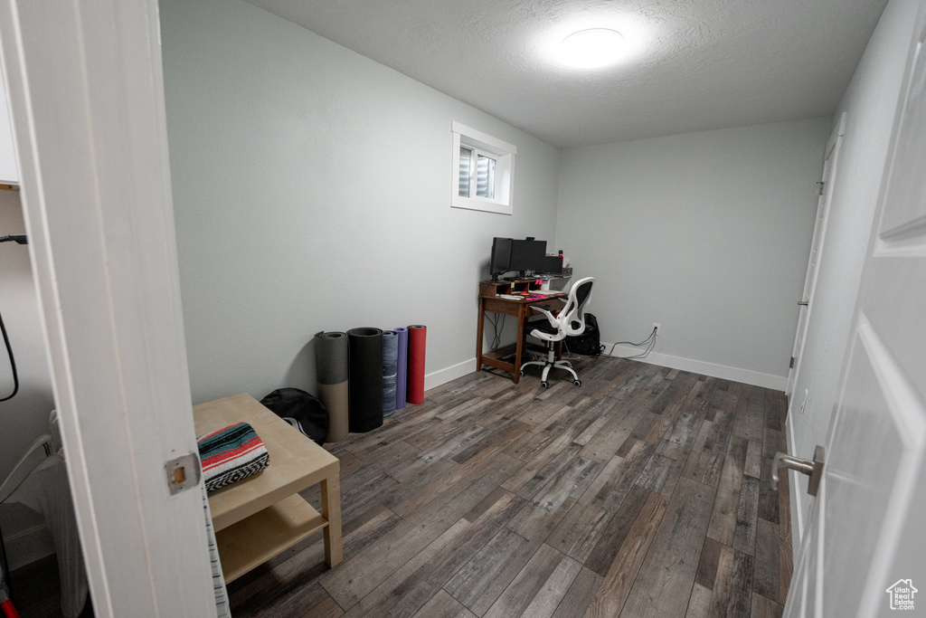 Office area with dark hardwood / wood-style floors and a textured ceiling