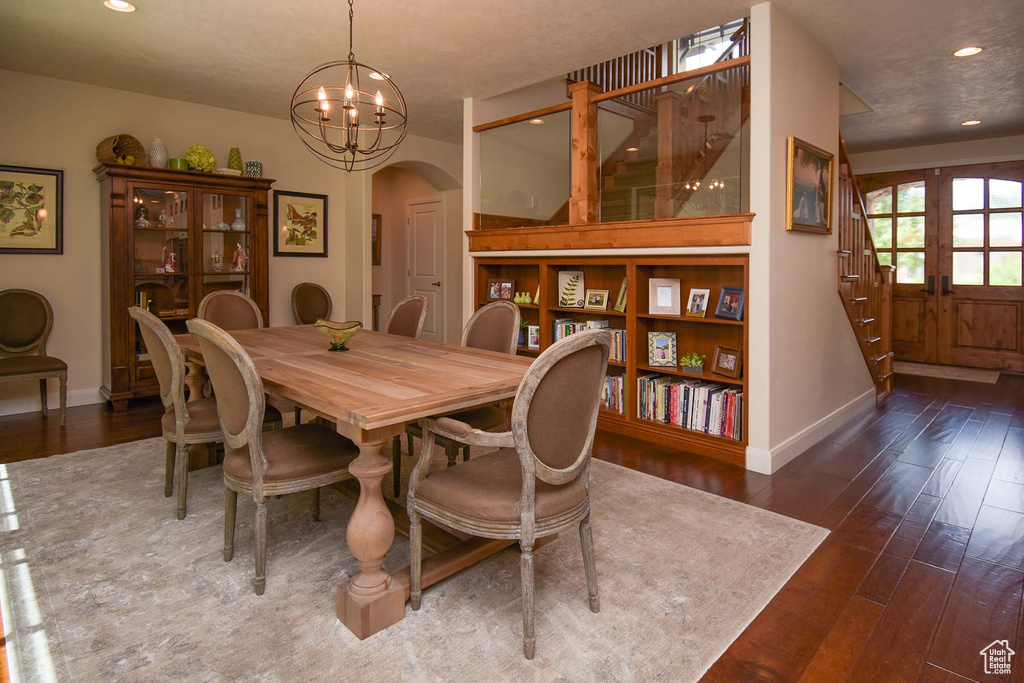 Dining room featuring french doors, a notable chandelier, and dark hardwood / wood-style floors
