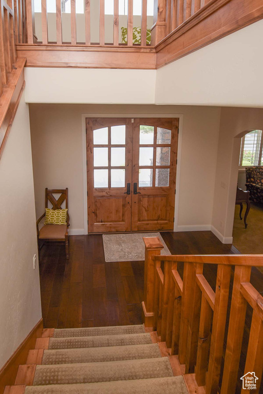 Entrance foyer with dark hardwood / wood-style flooring and french doors