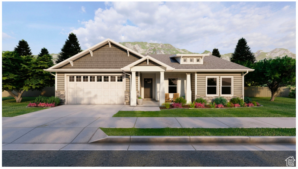 Craftsman house with a garage, a front lawn, and a mountain view