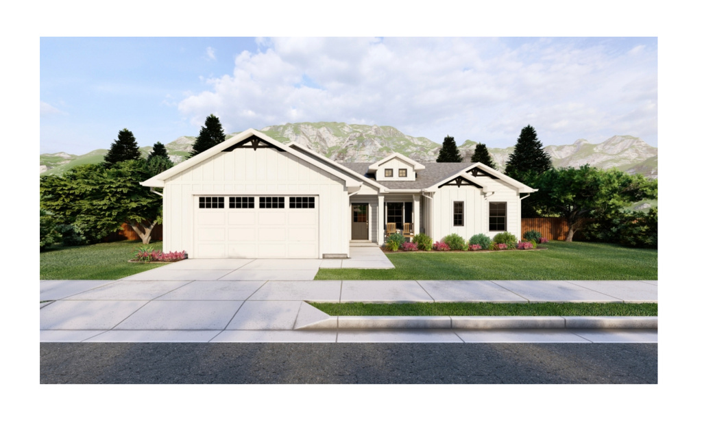 View of front of property with a garage, a front lawn, and a mountain view