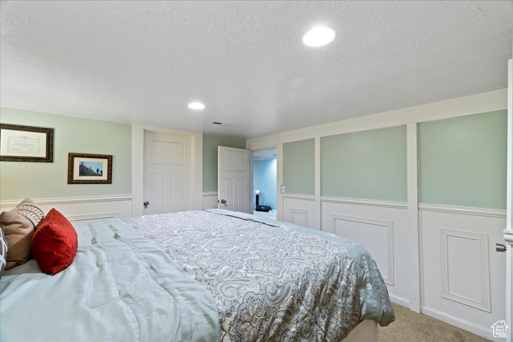 Bedroom featuring carpet floors and a textured ceiling