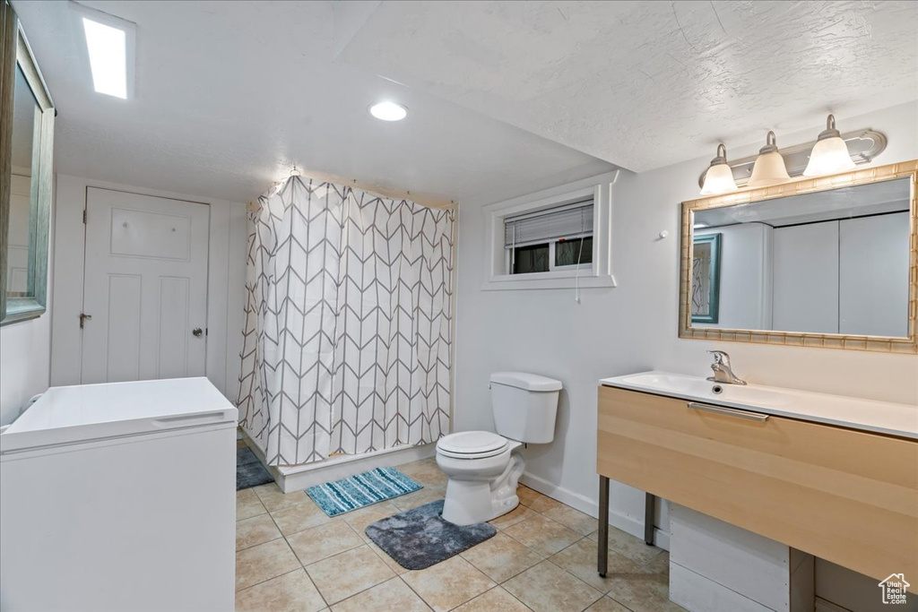 Bathroom with tile floors, toilet, and vanity