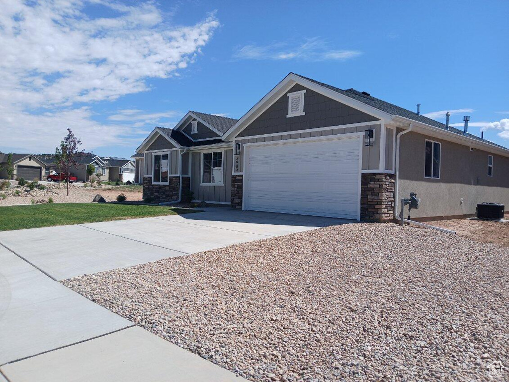 Craftsman-style home featuring central AC and a garage