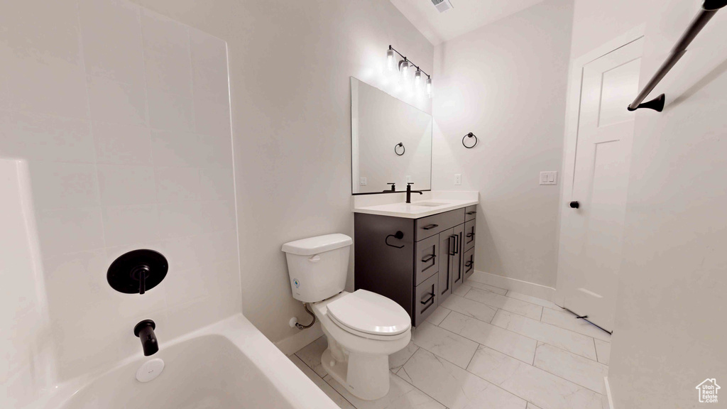 Bathroom featuring tile flooring, toilet, and vanity