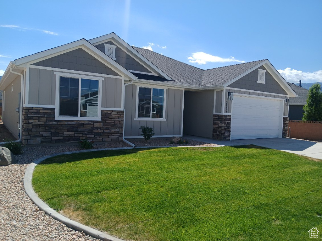 Craftsman-style home with a garage and a front lawn