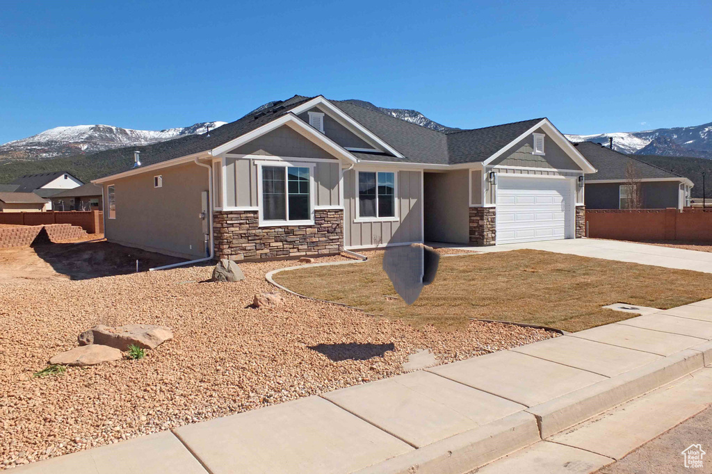 Craftsman-style home featuring a garage and a mountain view