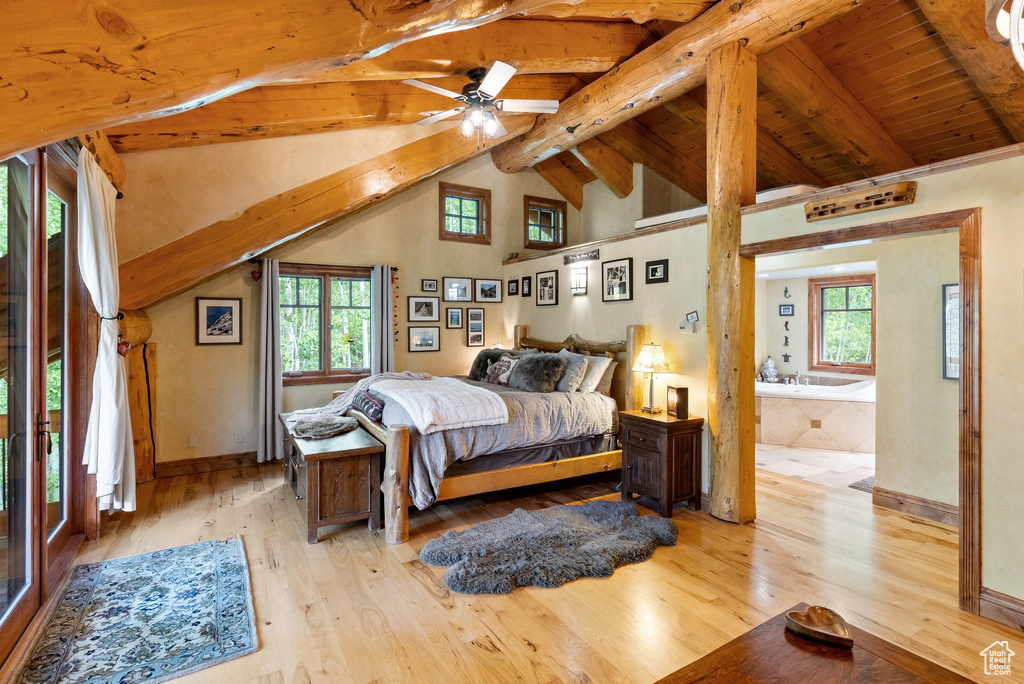 Bedroom featuring light hardwood / wood-style flooring, ensuite bath, multiple windows, and ceiling fan