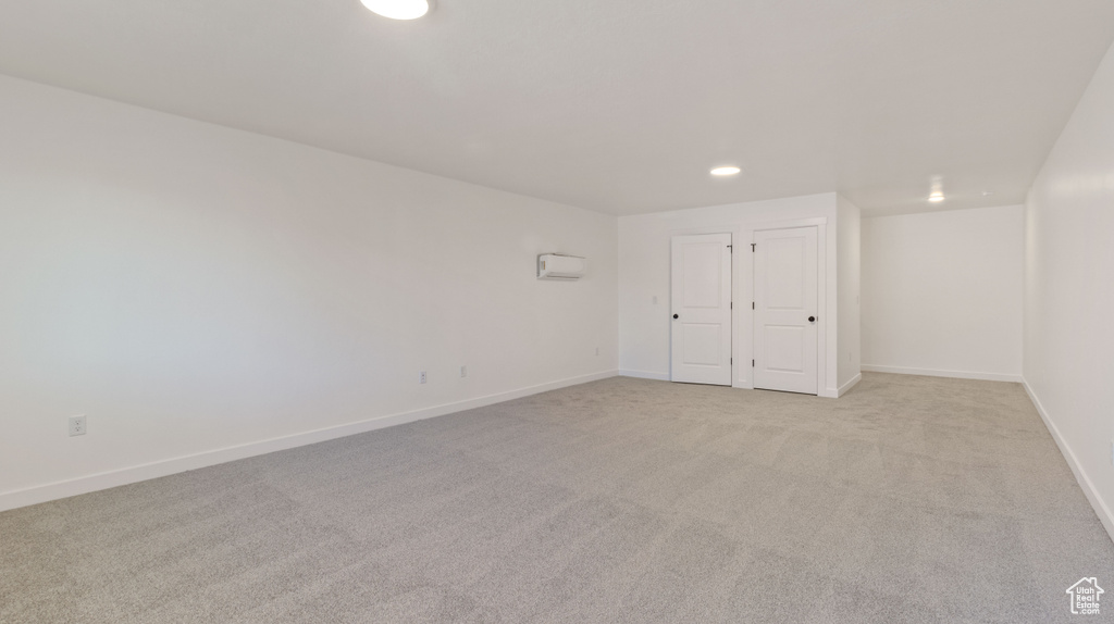 Interior space featuring light carpet and a closet
