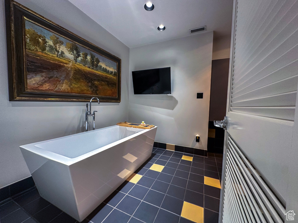 Bathroom with tile floors and a tub