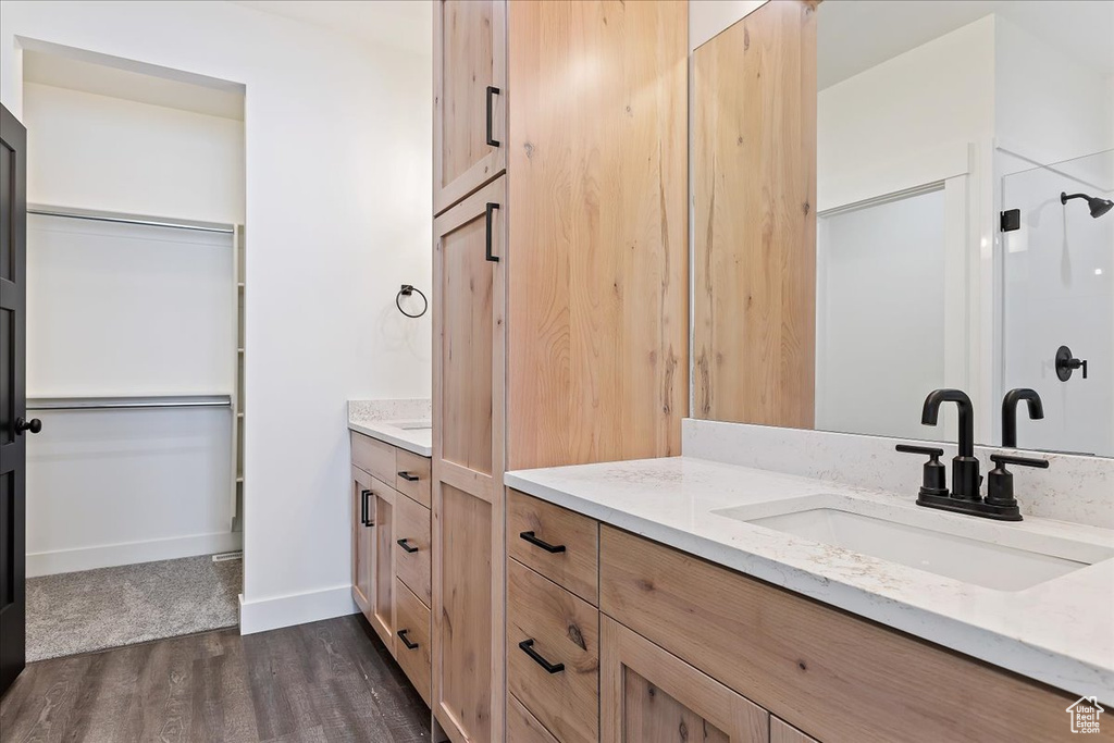 Bathroom featuring oversized vanity and hardwood / wood-style flooring