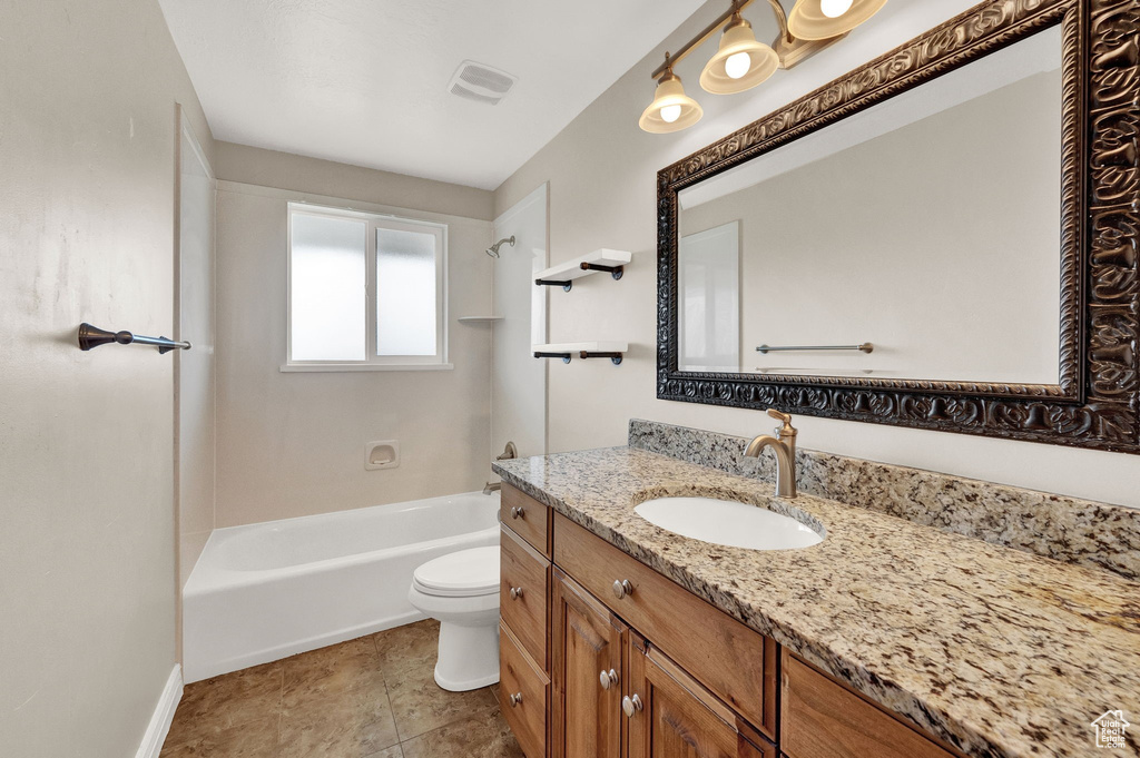 Full bathroom featuring shower / washtub combination, tile floors, vanity, and toilet