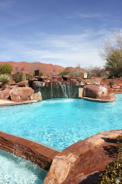 View of pool featuring pool water feature and a mountain view