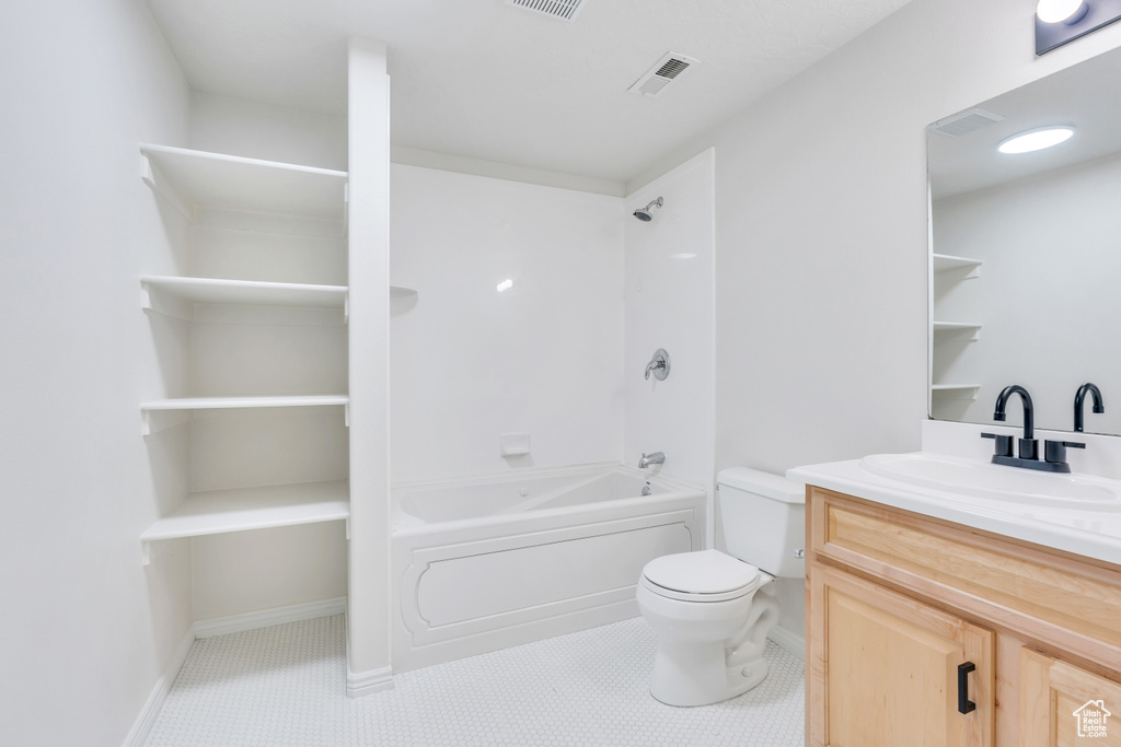 Full bathroom with tile floors, toilet, bathing tub / shower combination, and oversized vanity
