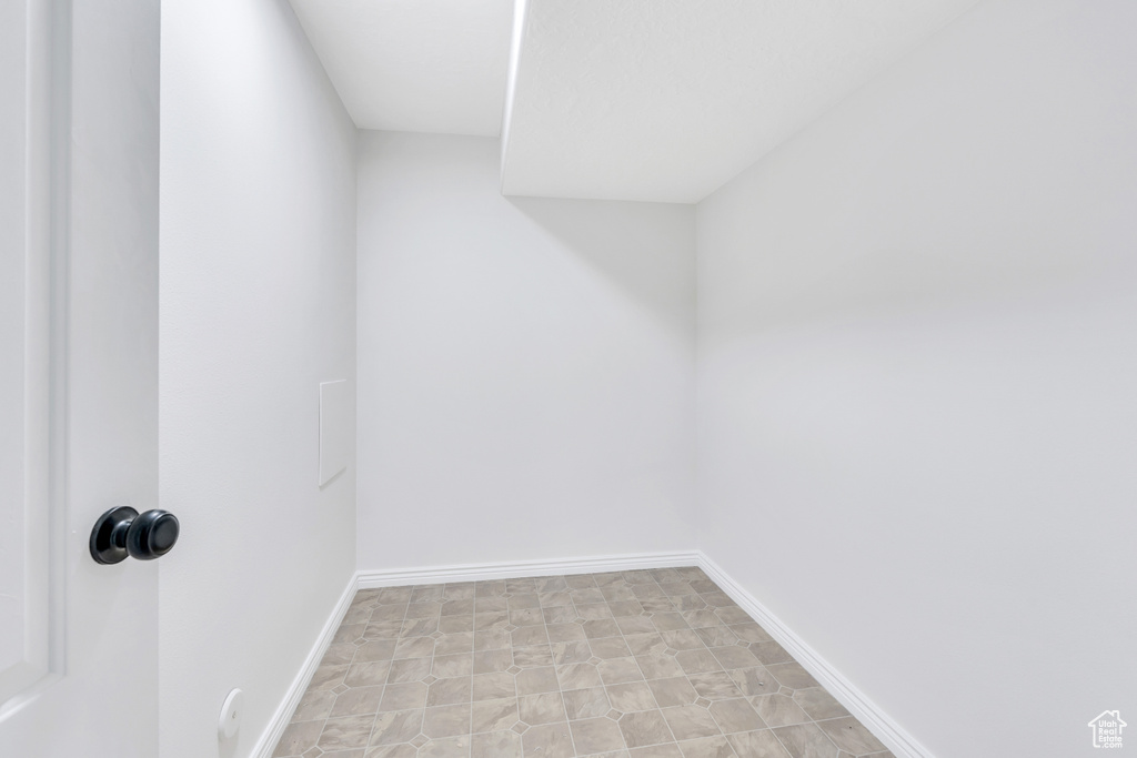 Unfurnished room with light tile floors