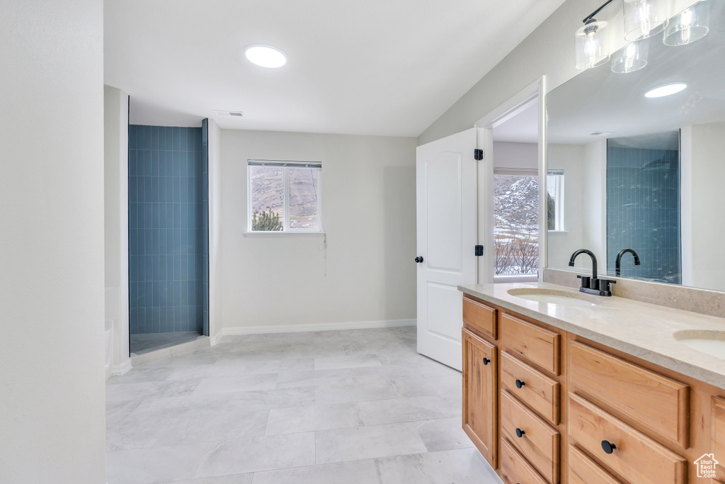 Bathroom featuring double sink vanity and tile flooring