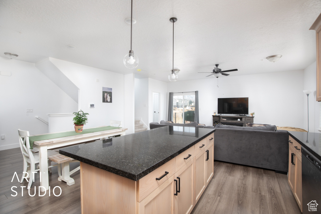 Kitchen with dishwasher, a kitchen island, dark wood-type flooring, and ceiling fan
