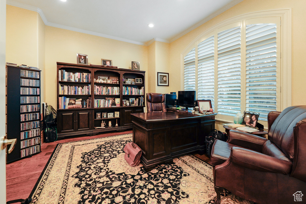 Home office with ornamental molding and dark wood-type flooring