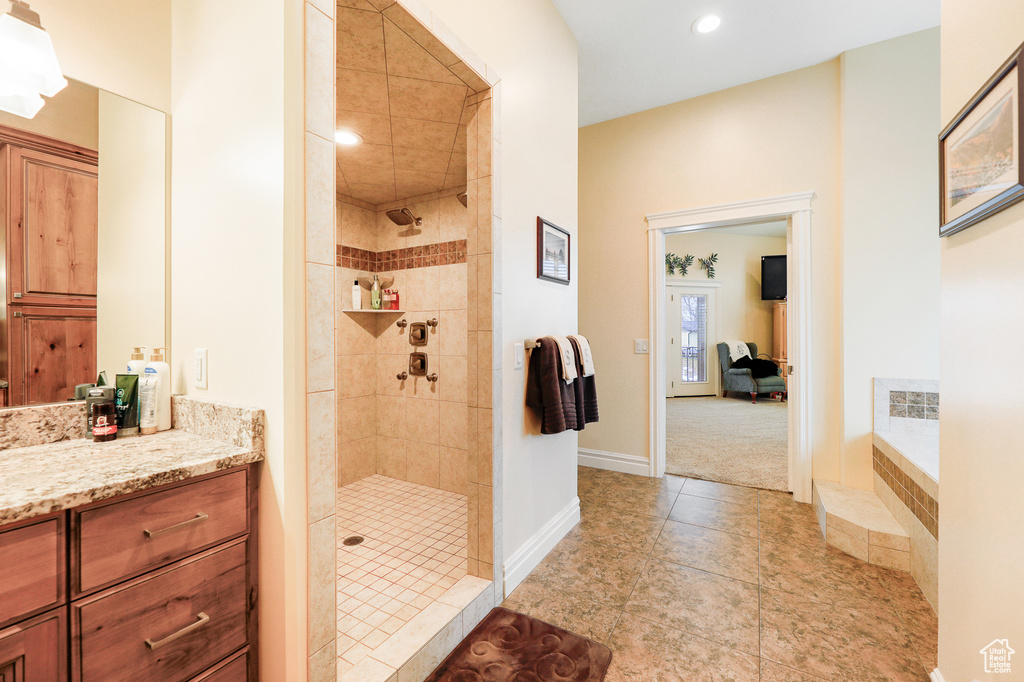 Bathroom with tile floors, separate shower and tub, and vanity with extensive cabinet space