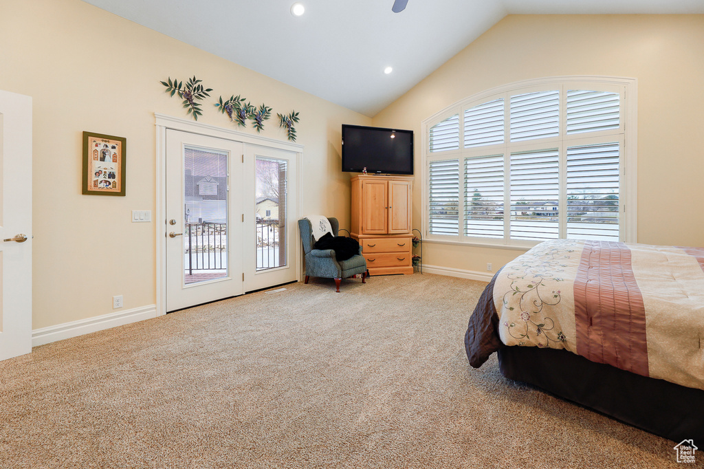 Carpeted bedroom with access to exterior, vaulted ceiling, and ceiling fan