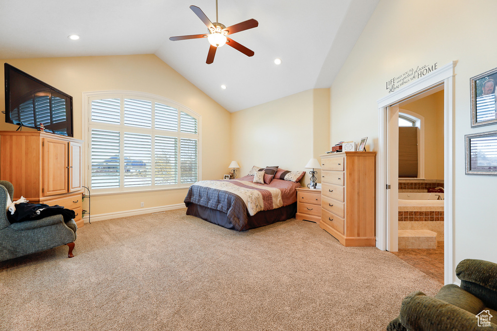 Carpeted bedroom with ensuite bath, high vaulted ceiling, and ceiling fan
