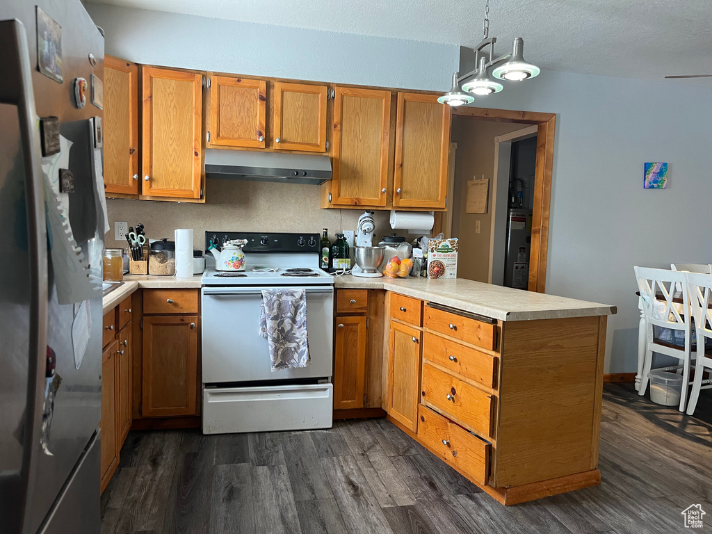 Kitchen with stainless steel refrigerator, an inviting chandelier, decorative light fixtures, dark hardwood / wood-style floors, and electric range
