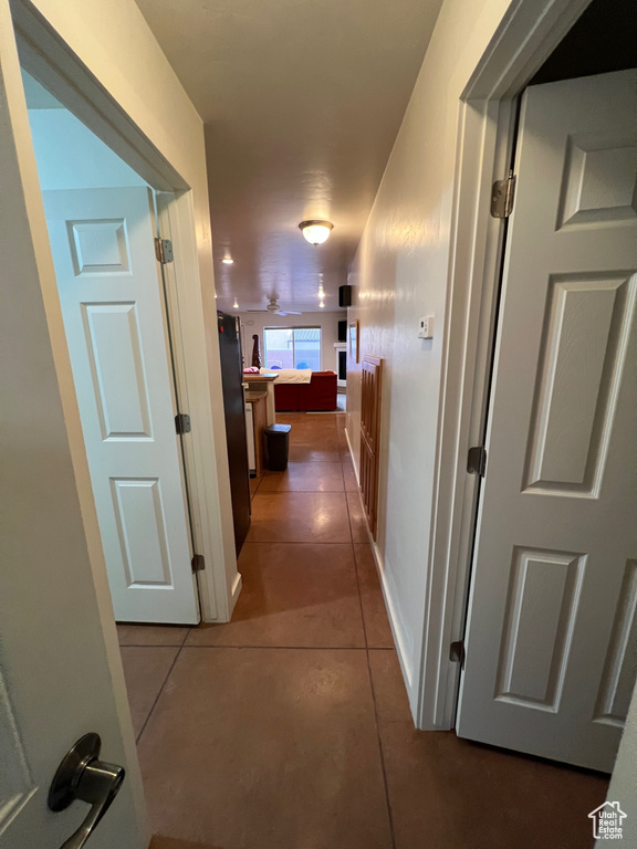 Corridor with dark tile floors