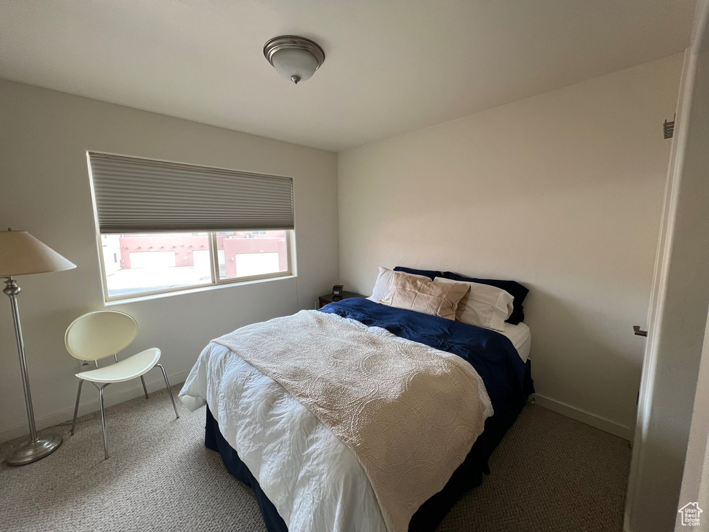 Bedroom with dark colored carpet