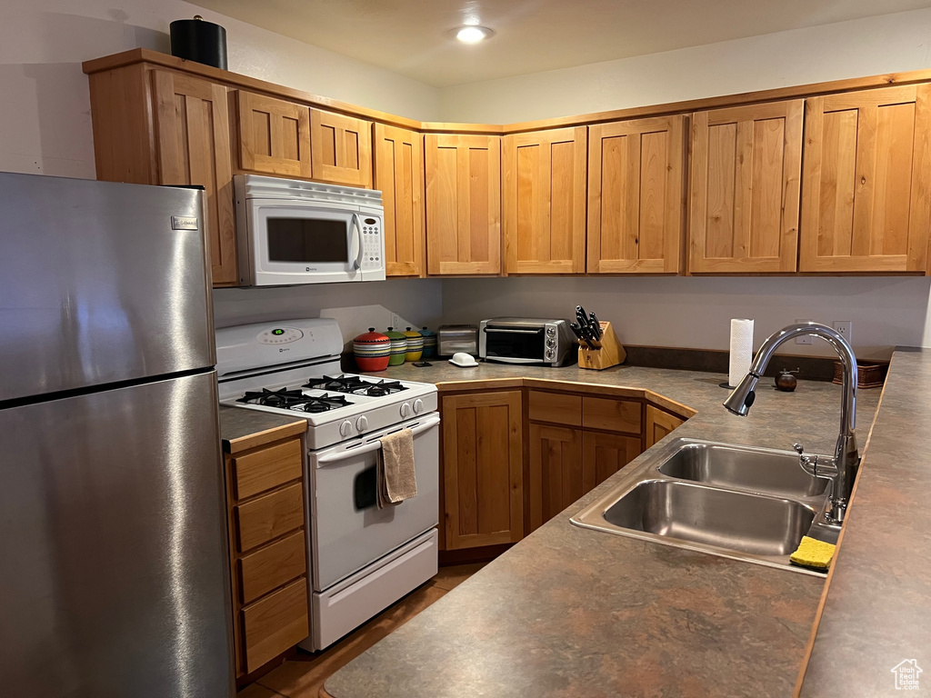 Kitchen with sink and white appliances