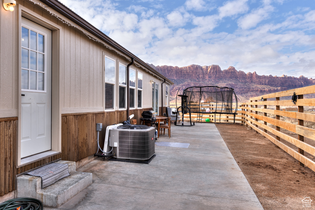 View of patio featuring central air condition unit, a gazebo, and a mountain view