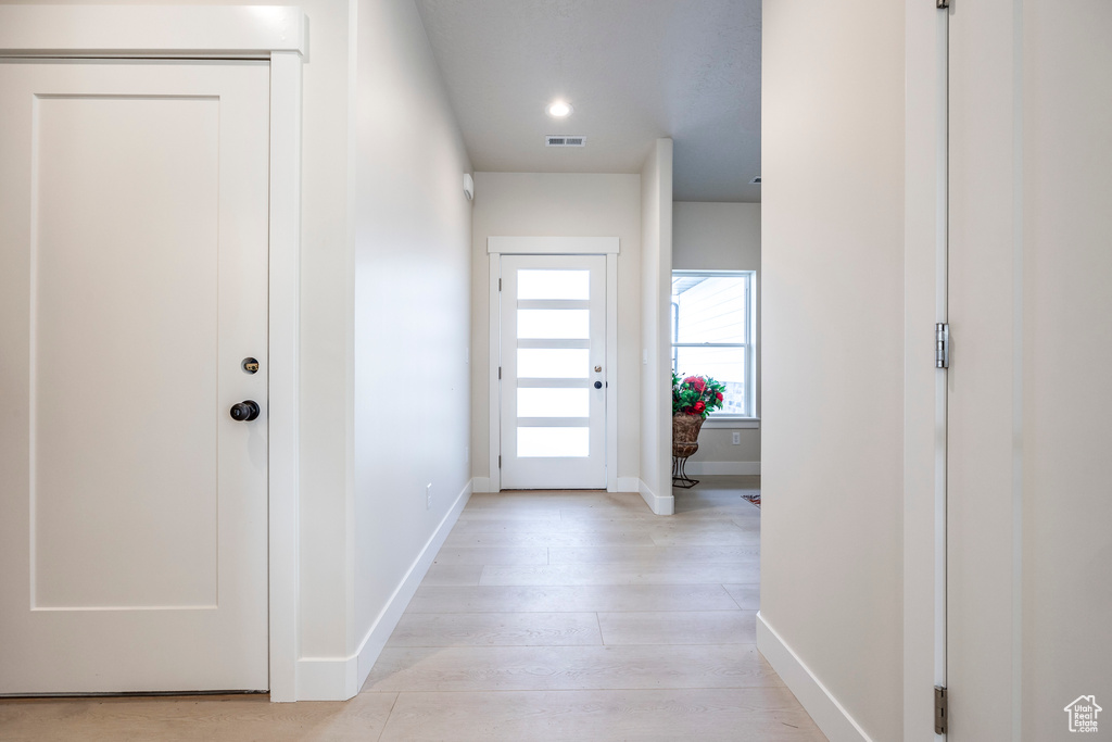 Doorway to outside with light hardwood / wood-style floors