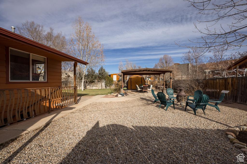 View of yard featuring a gazebo, a fire pit, and a patio area