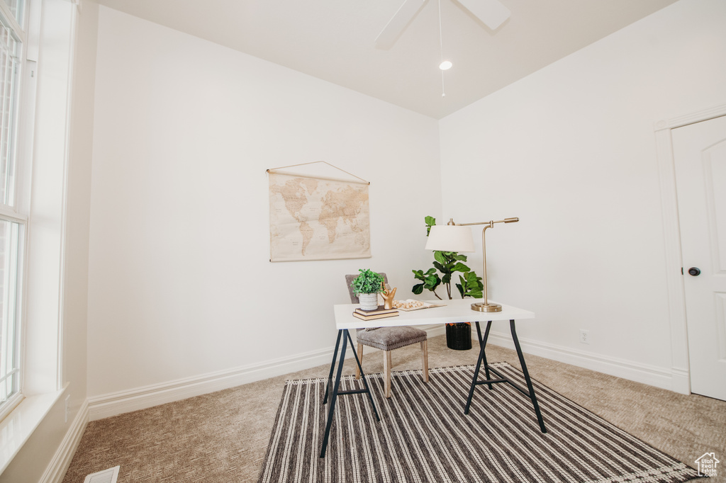 Office featuring light colored carpet and ceiling fan