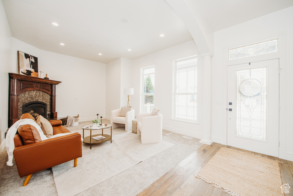 Living room featuring light hardwood / wood-style flooring and ornate columns