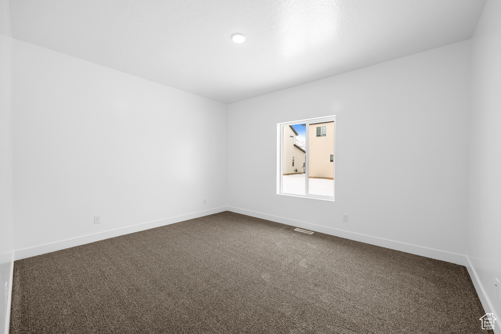 Spare room with dark carpet