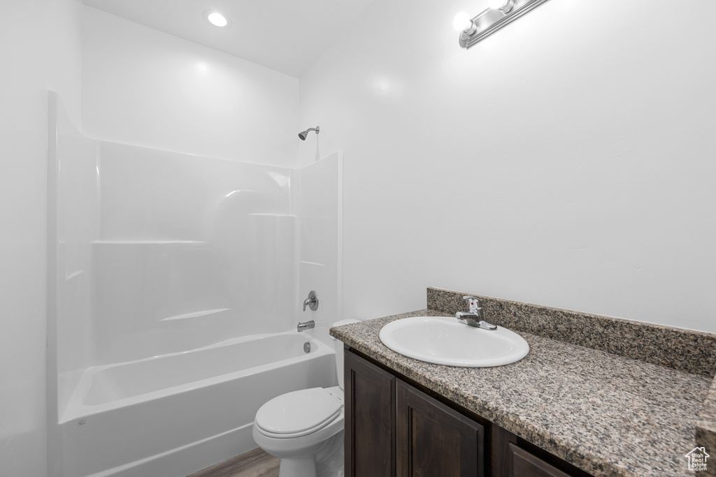 Full bathroom with toilet, vanity, and bathing tub / shower combination