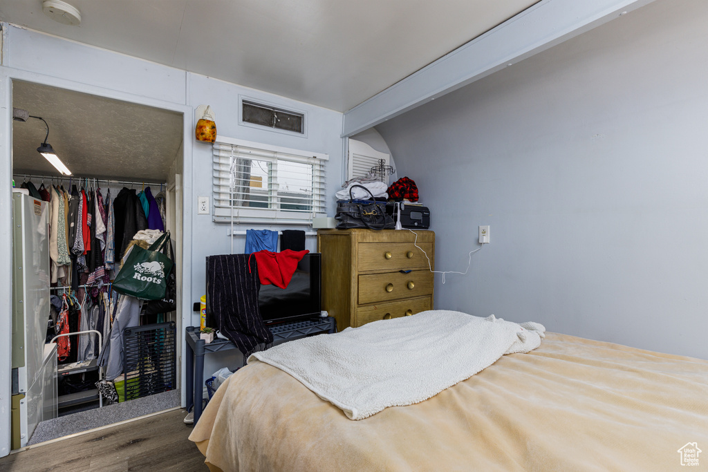 Bedroom featuring a closet and dark hardwood / wood-style floors